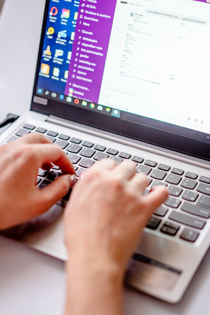 services-04 From above of crop anonymous female freelancing with netbook while using keyboard at table