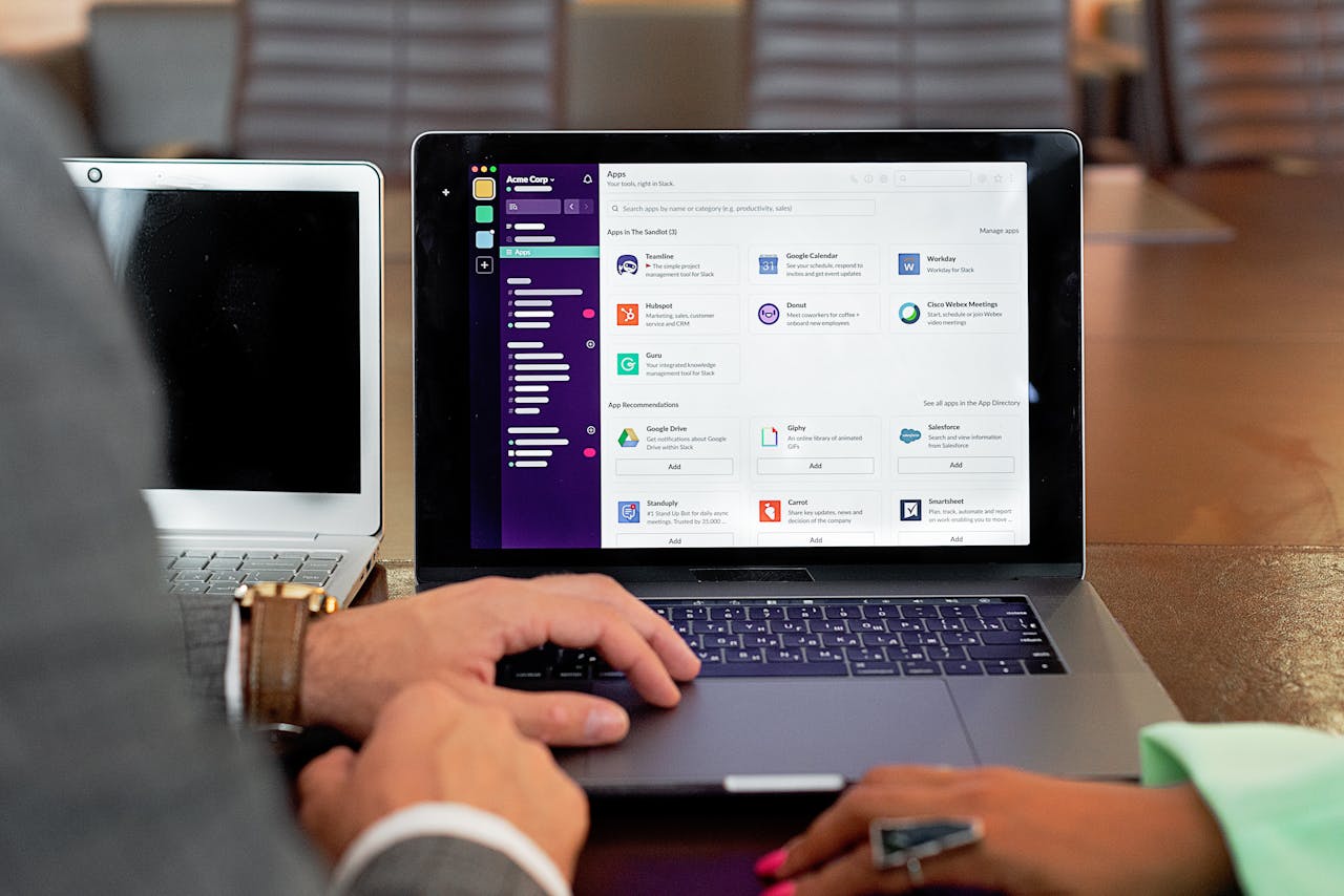 heros-img Two professionals collaborating using laptops and communication software in a business setting.